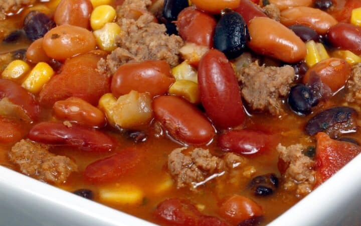 Close up image of Crockpot Taco Soup in a square white bowl