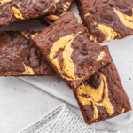 A stack of Peanut Butter Brownies on a white background