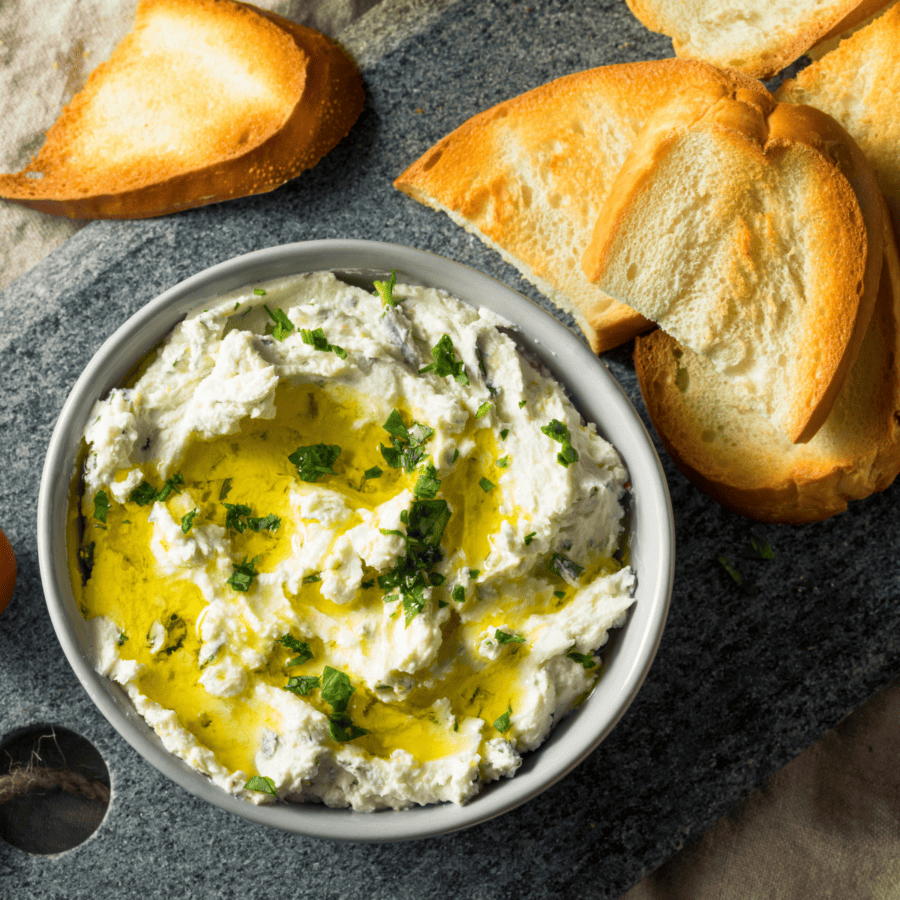 Overhead image of whipped feta dip in a bowl with bread