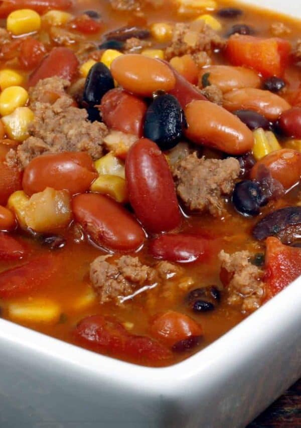 Close up image of Crockpot Taco Soup in a square white bowl
