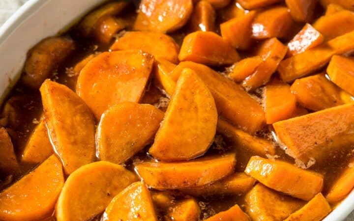 Overhead image of candied yams in a white dish