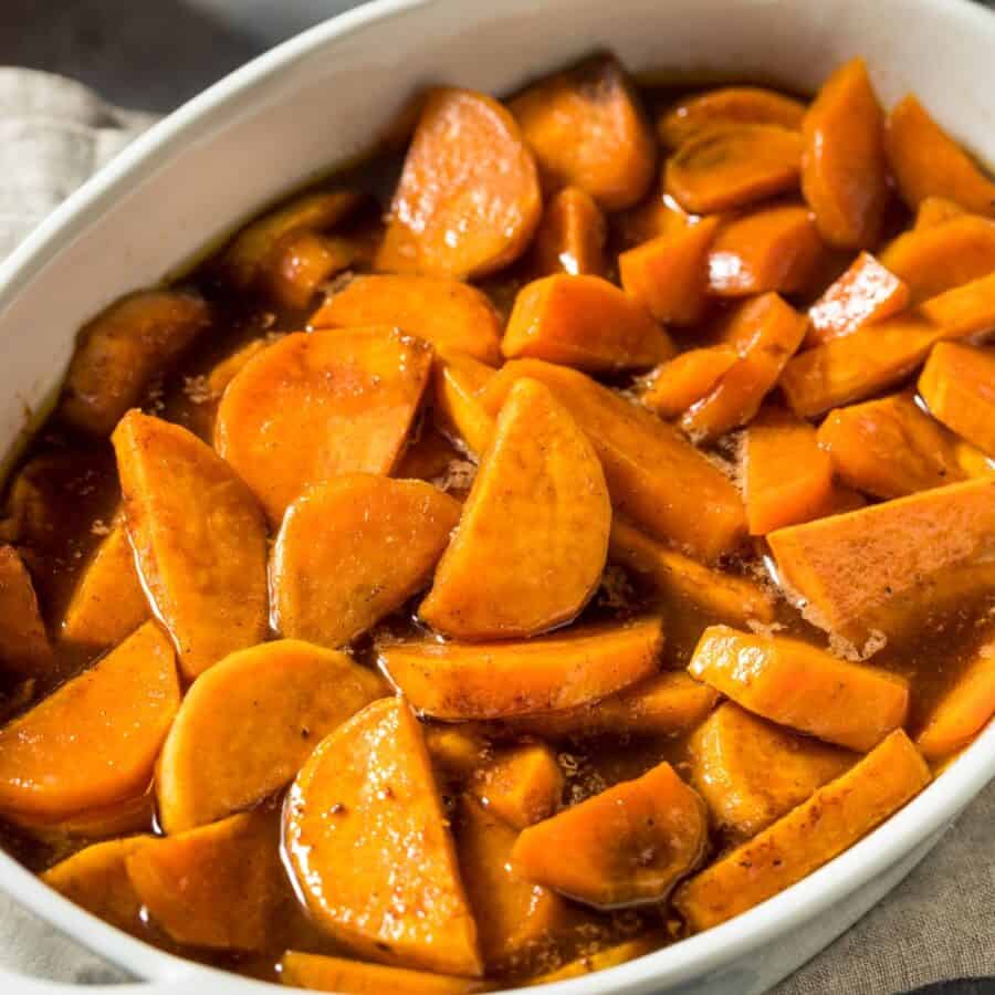 Overhead image of candied yams in a white dish