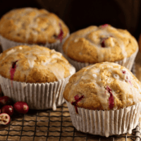 Close up image of Cranberry Orange Muffins on a cooling rack