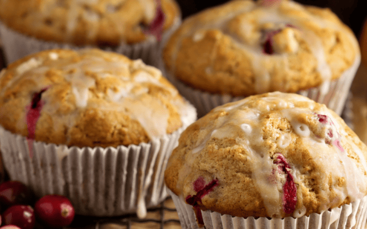 Close up image of Cranberry Orange Muffins on a cooling rack