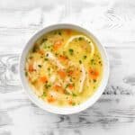 Overhead image of Lemon Chicken Orzo Soup in a bowl - 11