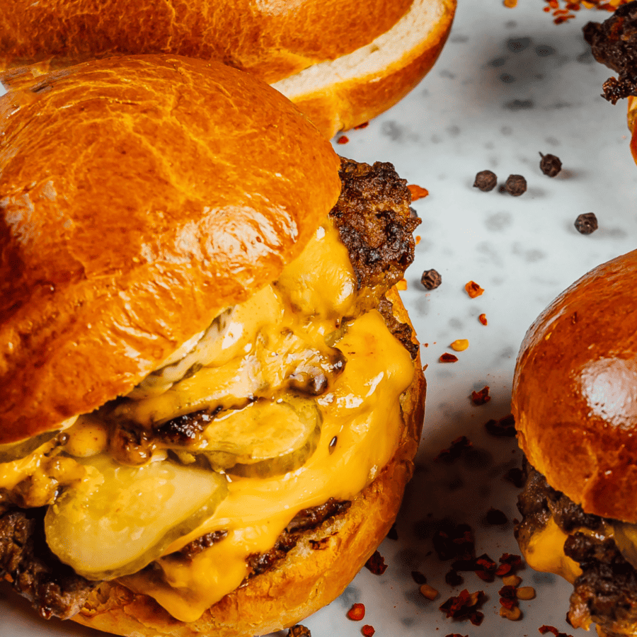 Close up image of smash burgers on a white background