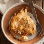 A slice of Turkey Pot Pie in a serving dish - 8