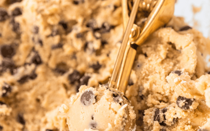 Chickpea Cookie Dough being portioned with a golden scoop