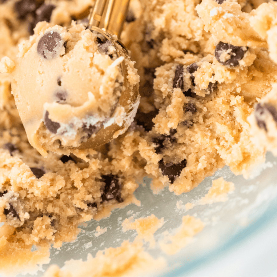 Close up image of Chickpea Cookie dough in a bowl being scooped