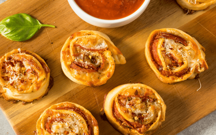 pizza pinwheels on a wooden cutting board