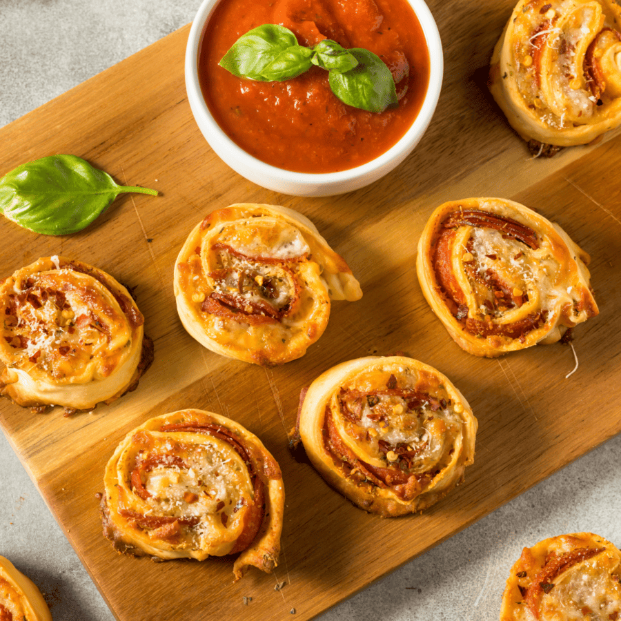 pizza pinwheels on a wooden cutting board