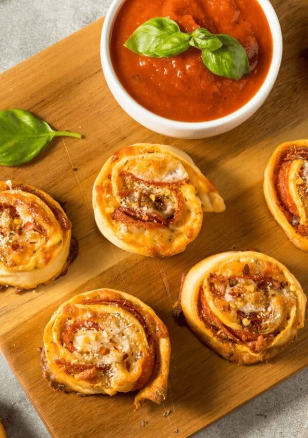 pizza pinwheels on a wooden cutting board