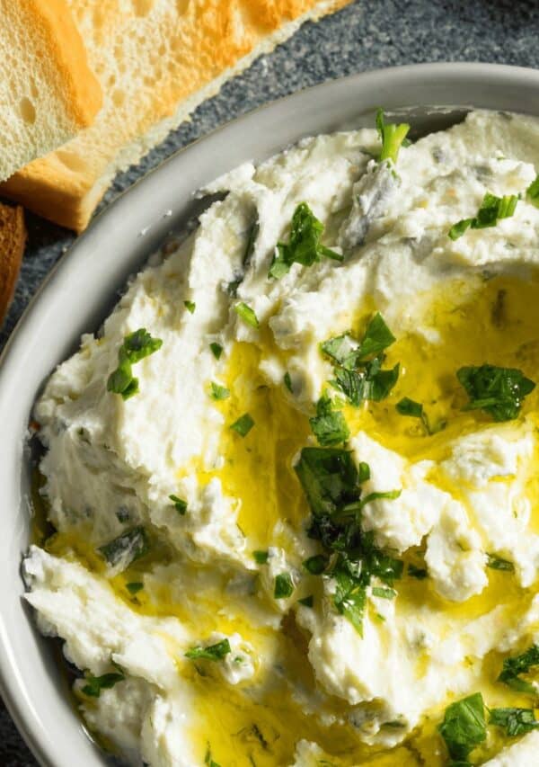 Close up image of whipped feta dip drizzled with olive oil