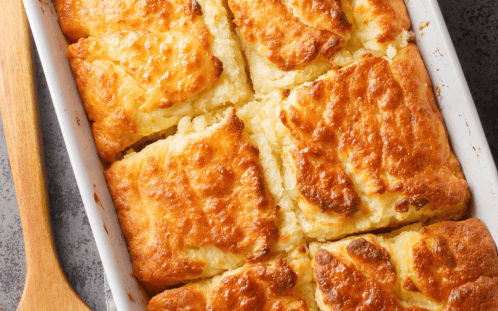 Overhead image of Butter Swim Biscuits in a rectangular pan with a wooden spatula