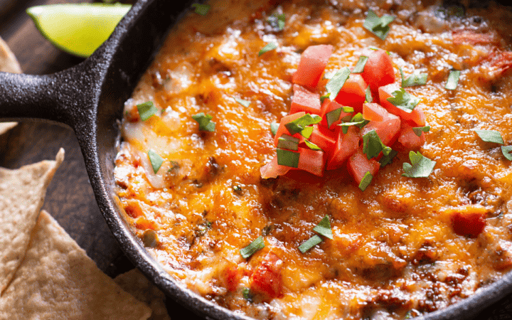 Overhead image of Skillet queso with tortilla chips and lime on the side
