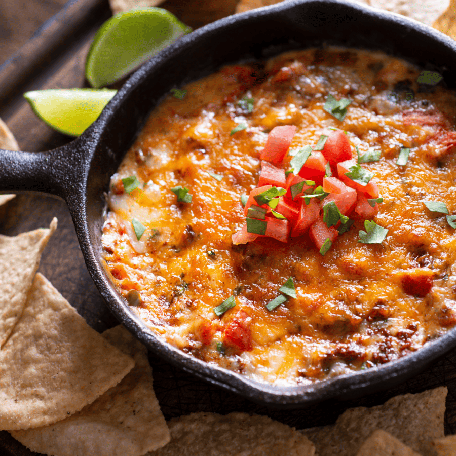 Overhead image of Skillet queso with tortilla chips and lime on the side