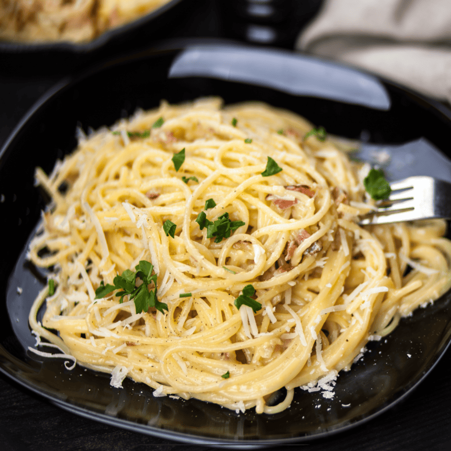 Overhead image of Spaghetti Carbonara on a black plate