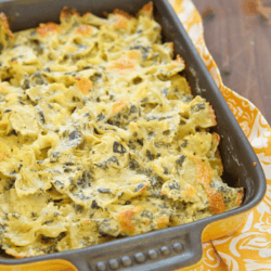 Spinach artichoke pasta in a yellow baking dish
