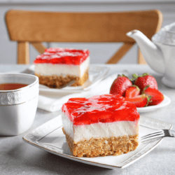 Two pieces of Strawberry Pretzel Pie on square plates