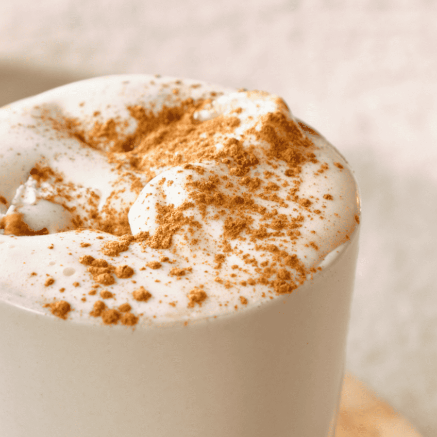 close up image of white chocolate hot chocolate in a white mug