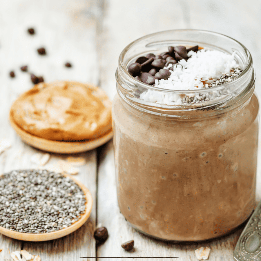Chocolate overnight oats in a mason jar with chia seeds, peanut butter, and chocolate chips