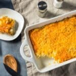 Overhead image of hashbrown casserole in a baking dish with a plate next to it - 8