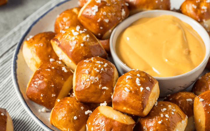 Pretzel Bites on a plate with a bowl of cheese dip