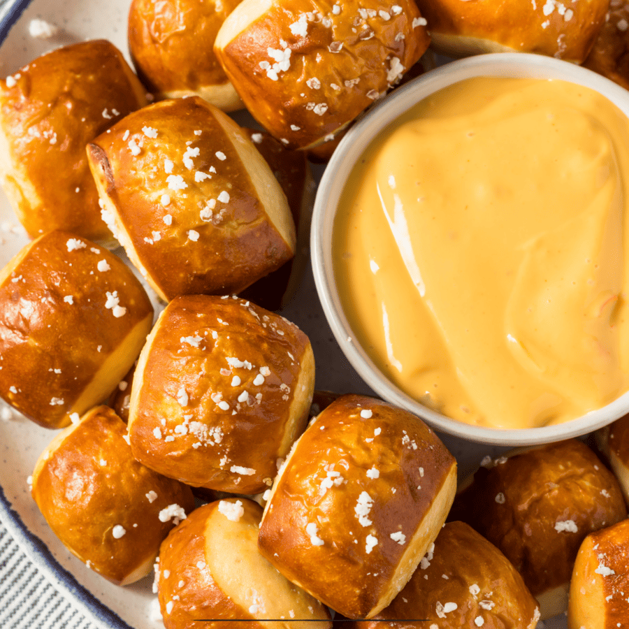 overhead image of soft pretzel bites with a small bowl of cheese sauce