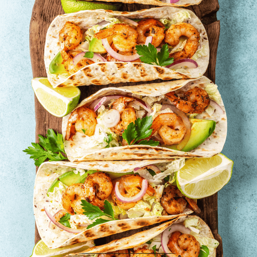 Overhead image of Shrimp Tacos on a wooden cutting board