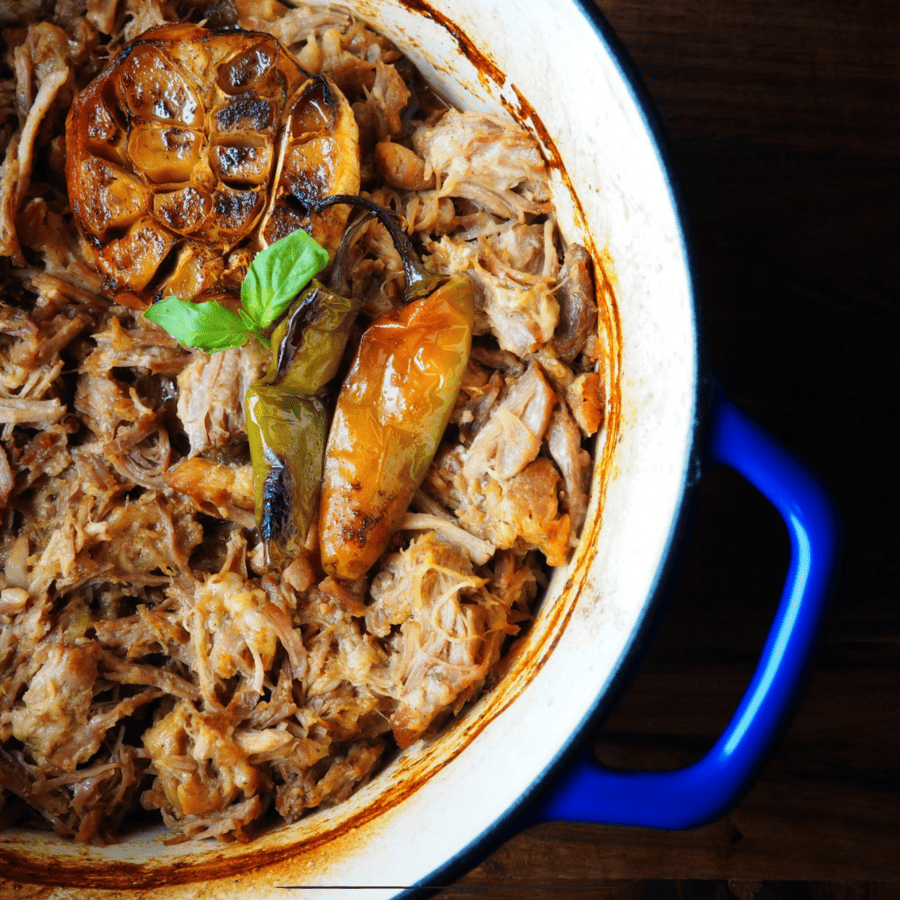Slow Cooker Carnitas meat in a blue and white dutch oven