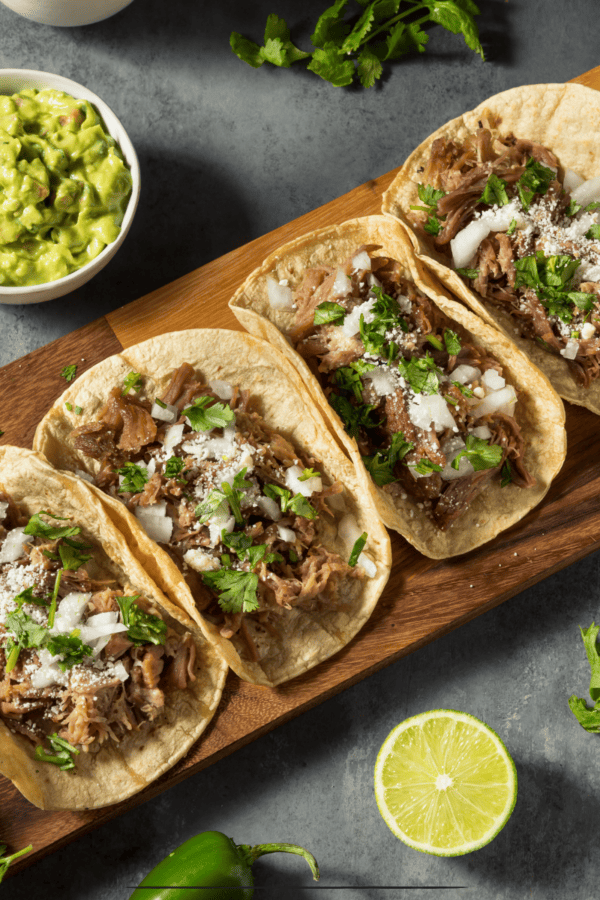 4 Slow Cooker Carnitas on a wooden cutting board