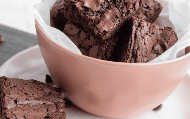 Close up image of Vegan Brownies in a bowl sitting on a saucer