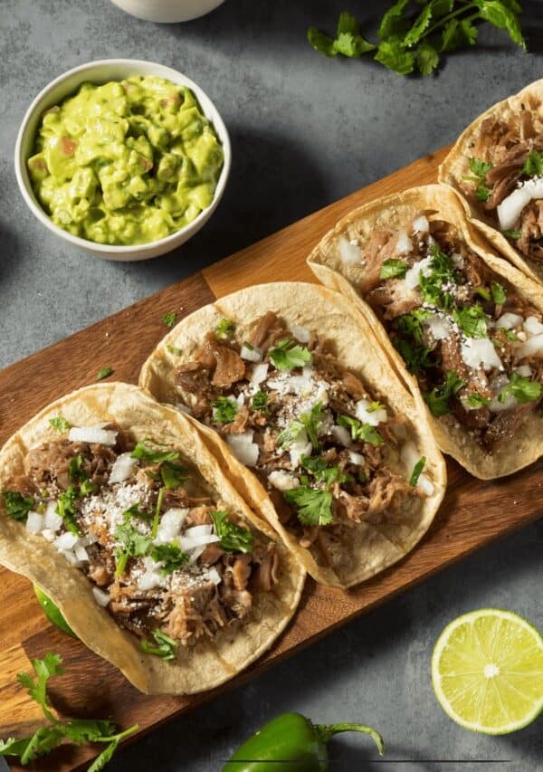 4 Slow Cooker Carnitas on a wooden cutting board