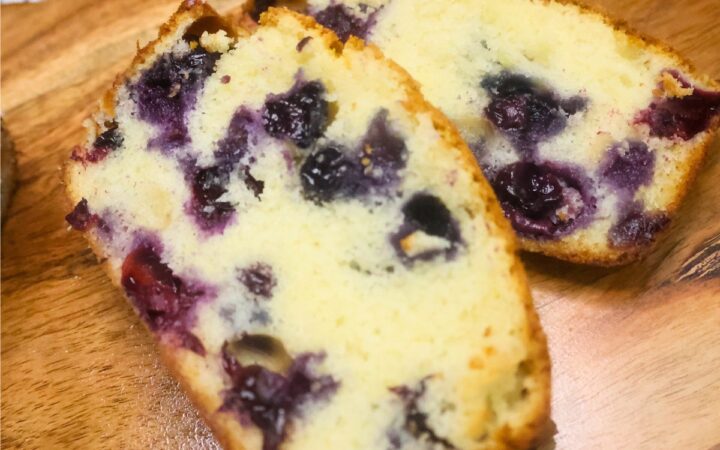 Close up image of two slices of blueberry loaf cake