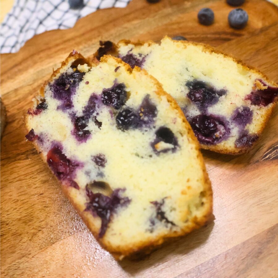 Close up image of two slices of blueberry loaf cake