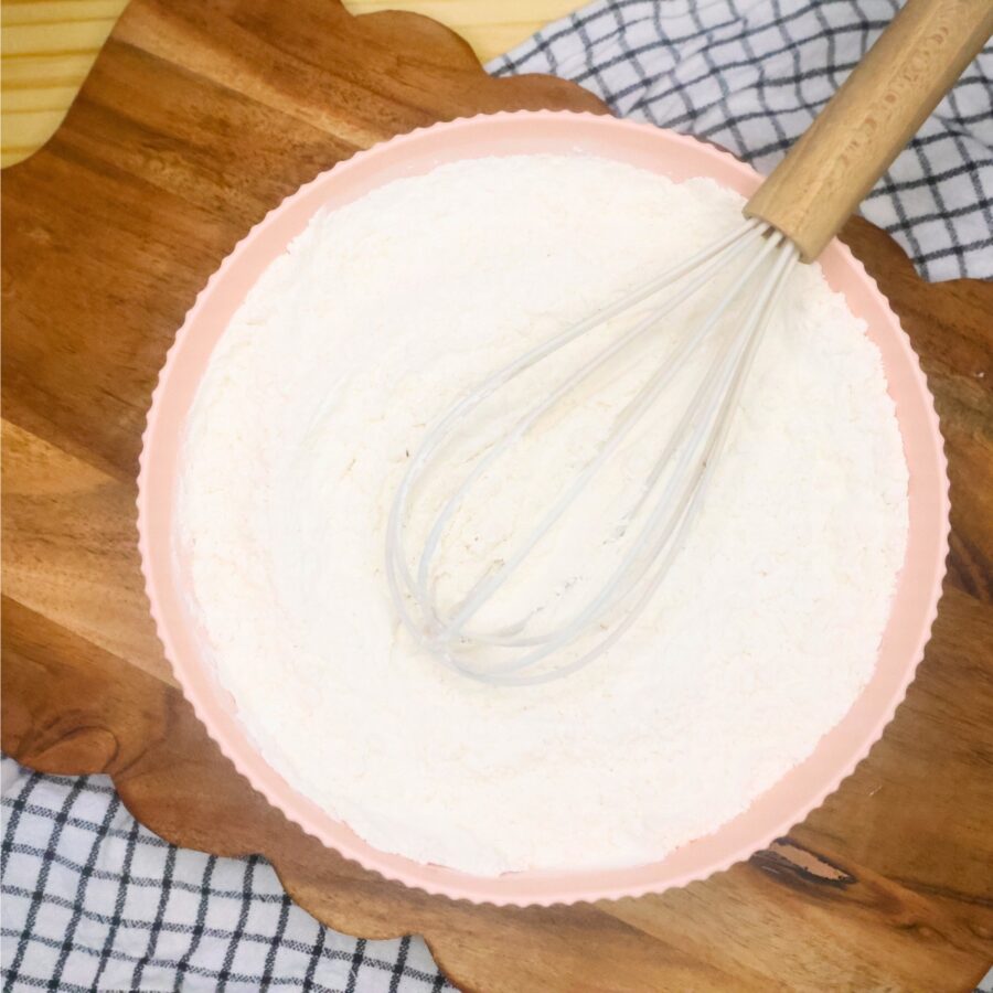 Dry ingredients for blueberry loaf cake in a bowl with a whisk