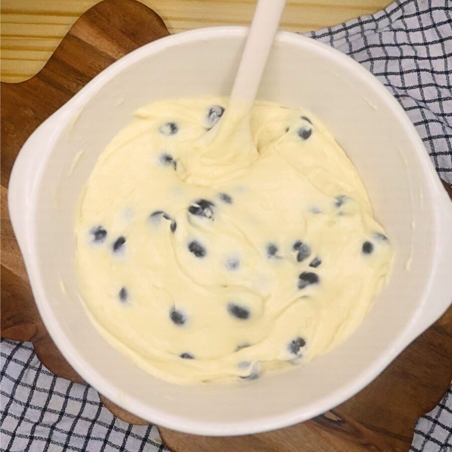 Blueberries folded into loaf cake batter