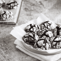 Chocolate Cool Whip Cookies on a plate with a pan of them sitting next to it