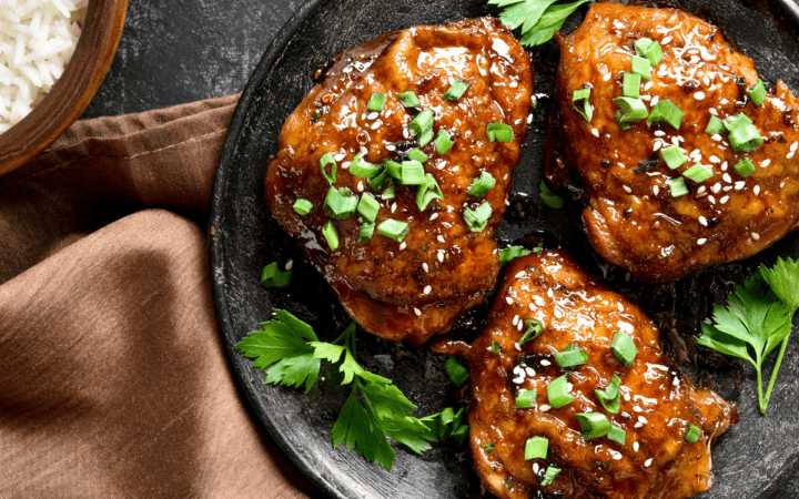Overhead image of Honey Garlic Chicken Thighs on a black plate
