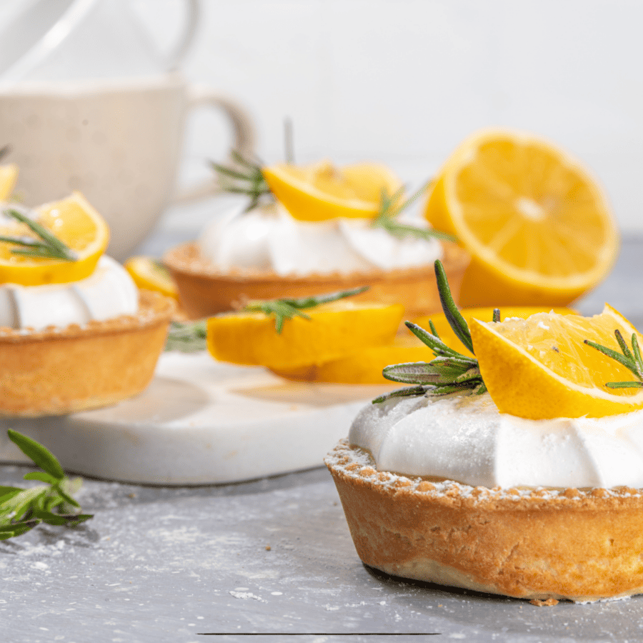 Mini Lemon Tarts with lemon and whipped cream garnish