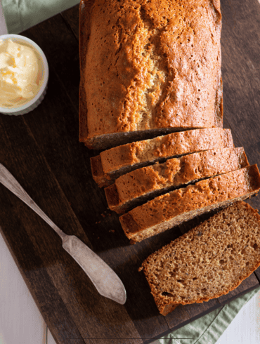 Overhead image of almond flour banana bread on a wooden cutting board