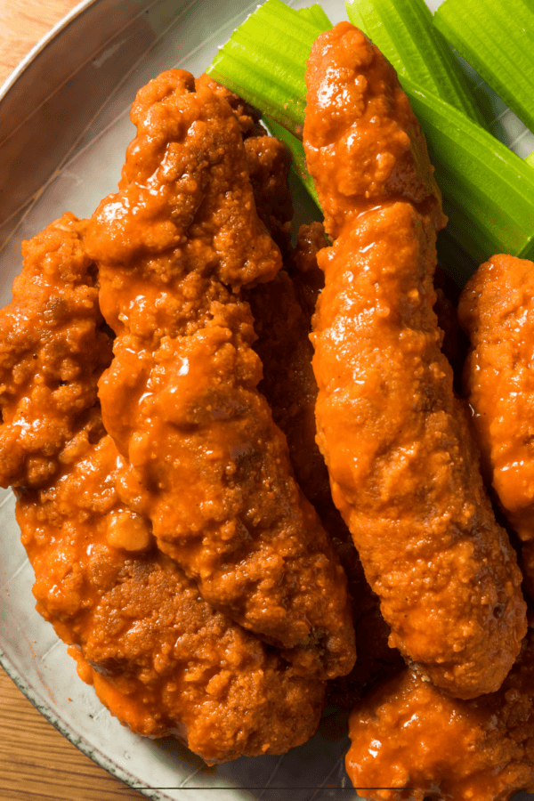 Buffalo Chicken Tenders on a plate with celery sticks