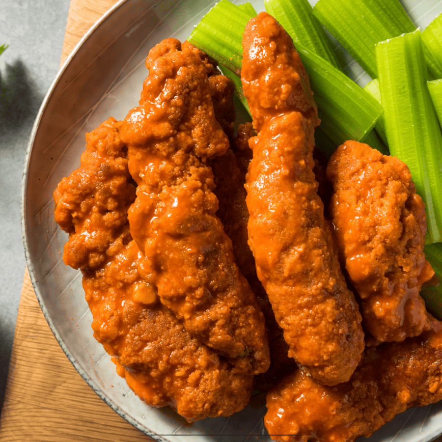 Buffalo Chicken Tenders on a plate with celery sticks