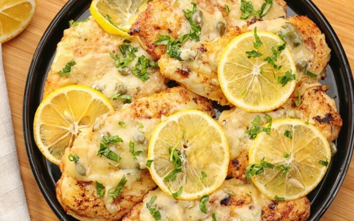 Overhaed image of Chicken Piccata on a black plate