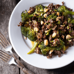 Overhead image of ground beef and broccoli on a white plate