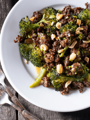 Overhead image of ground beef and broccoli on a white plate