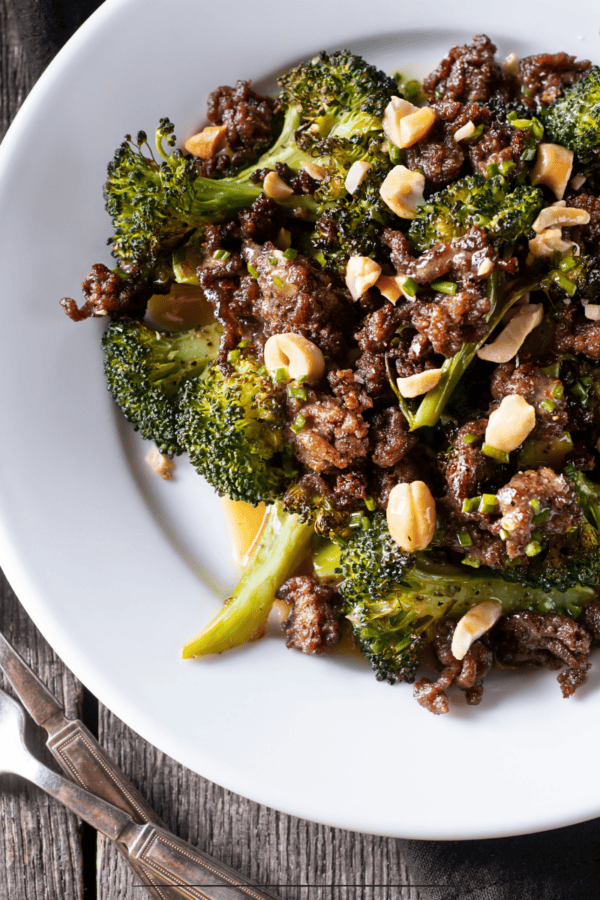 Overhead image of ground beef and broccoli on a white plate