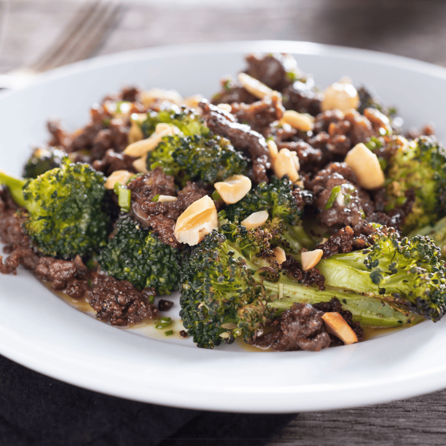Ground beef and broccoli on a white plate