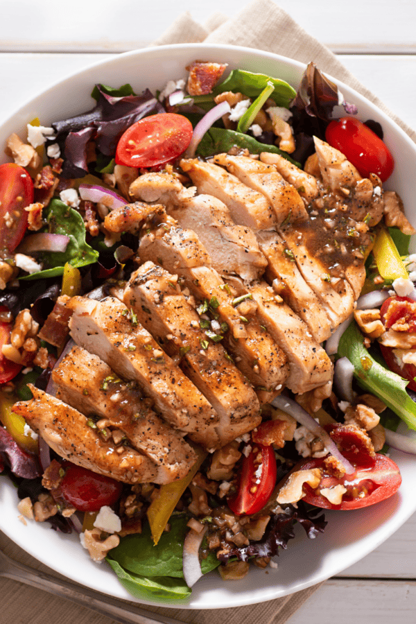 Overhead image of Honey Balsamic Chicken over a fresh salad