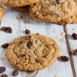 Close up image of Oatmeal Raisin Cookies with raisins sprinkled around them